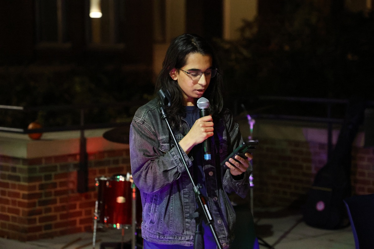 Student performing spoken word at outdoor night event