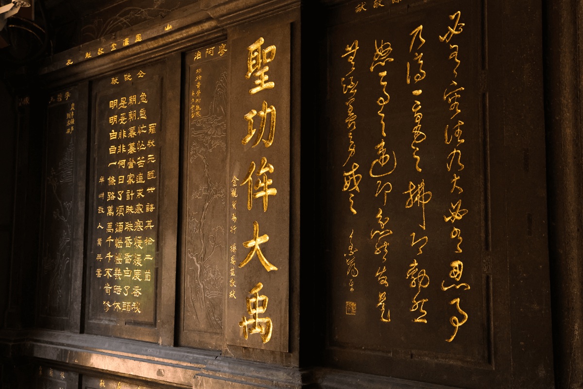 Visitor studying a sepia calligraphy scroll