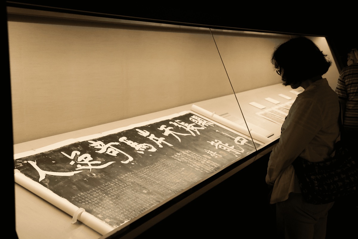 Gold calligraphy on dark temple wall