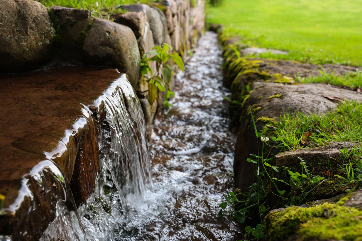 Mossy stone water channel with small cascade