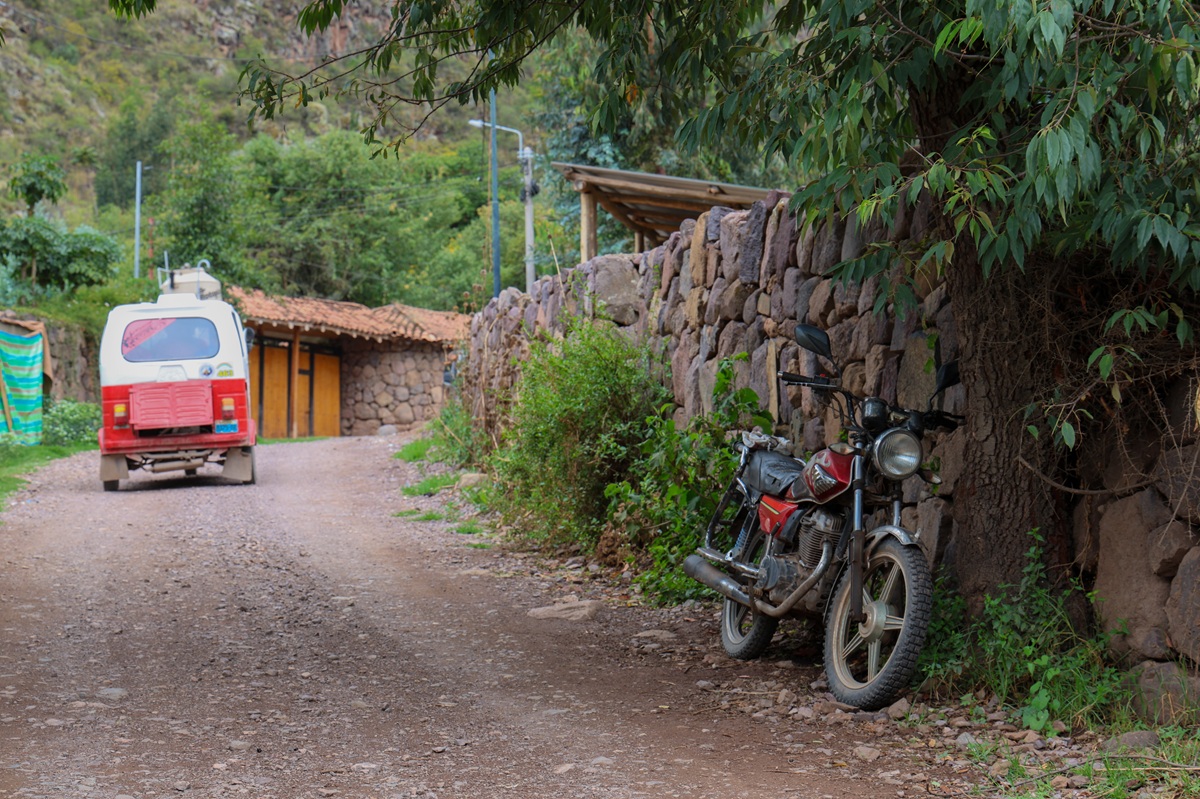 Dirt road with tuk-tuk and motorcycle