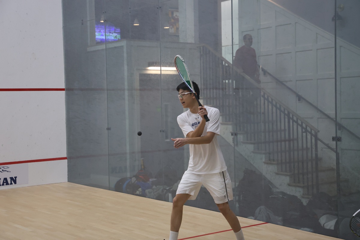 Gilman squash player preparing backhand shot