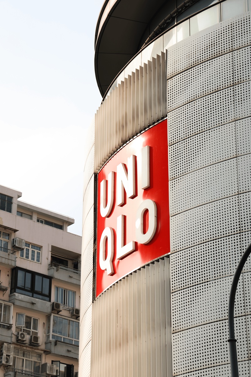 Uniqlo sign on curved silver building facade