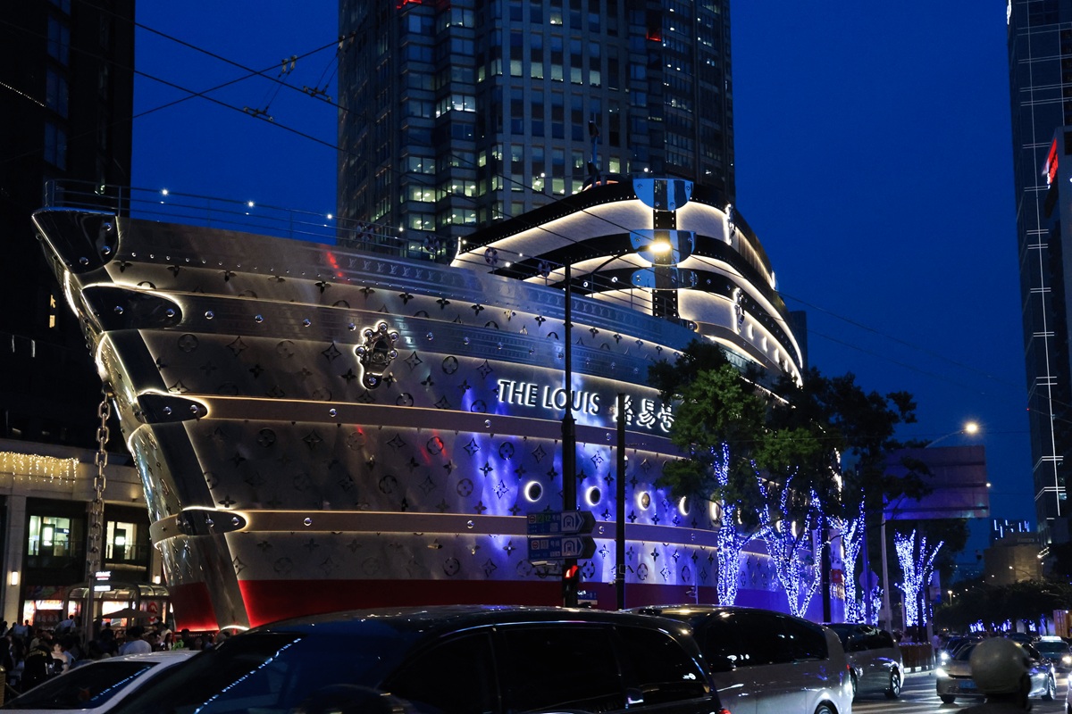 The Louis LV flagship building lit in blue at night