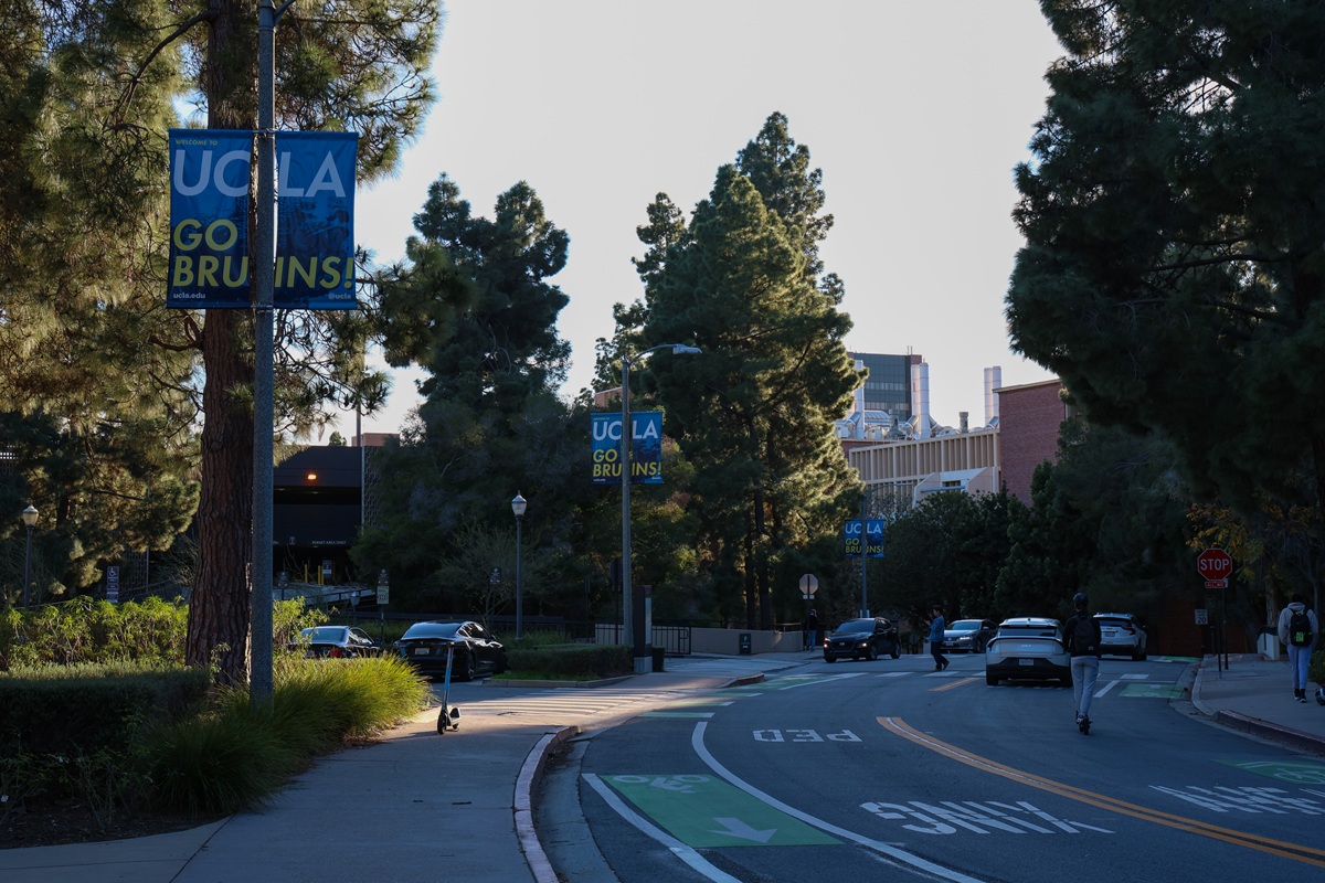UCLA campus road with Go Bruins banners at dusk