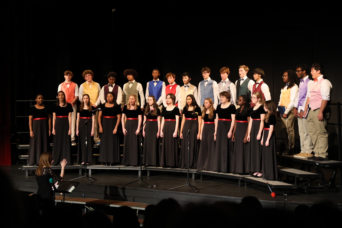 Combined choir with girls in red-sashed dresses