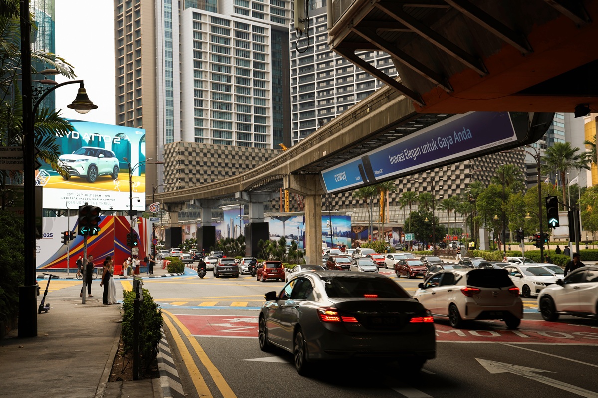 KL city street with monorail track and billboard