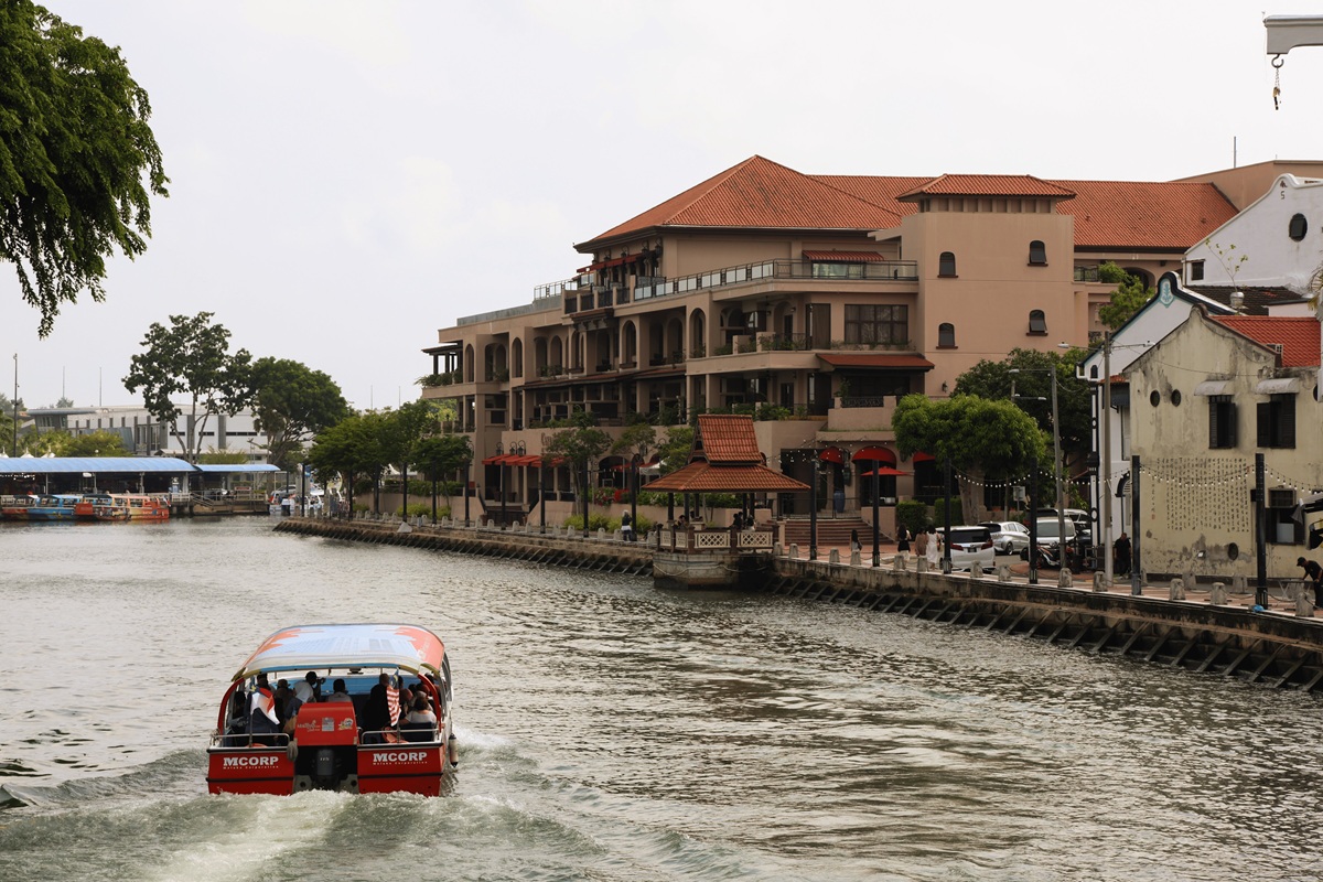 Red MCORP river cruise boat on the Melaka River