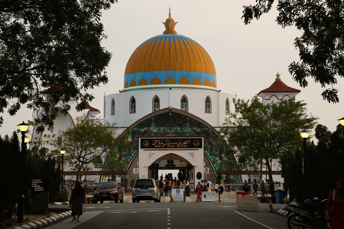 Masjid Selat Melaka mosque with golden dome framed by trees