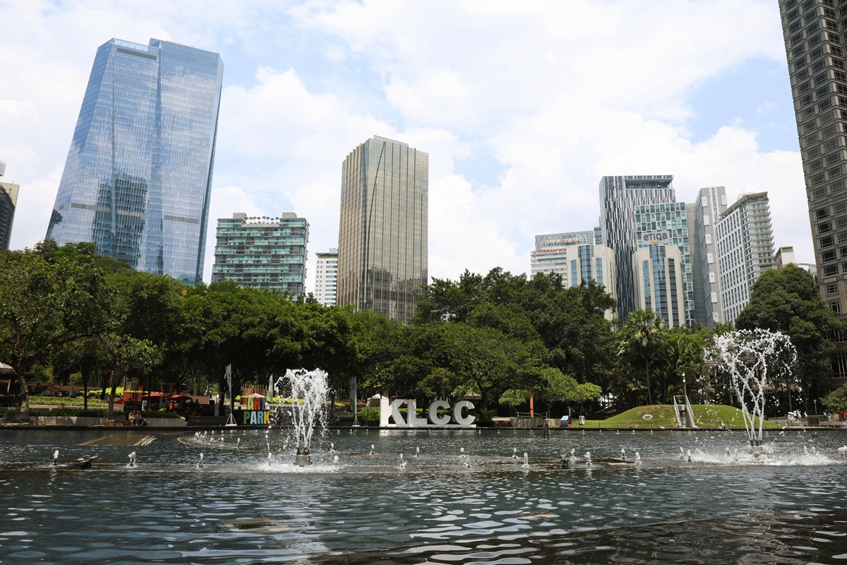 KLCC park fountain with city skyline in daytime