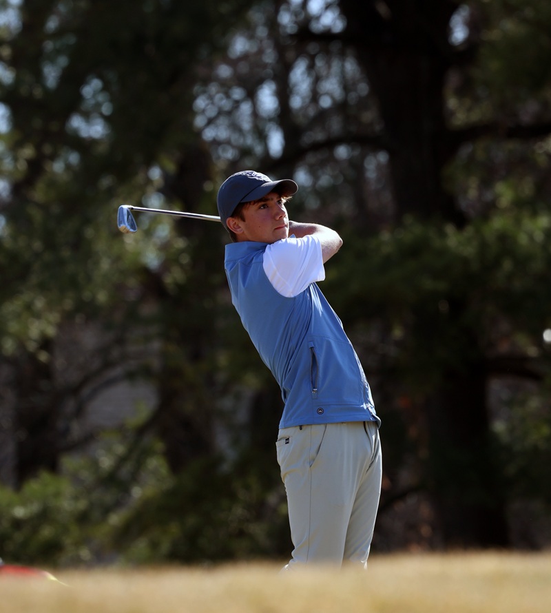Gilman golfer following through on iron shot