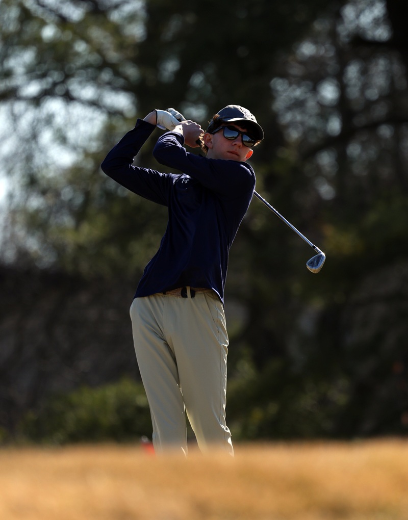 Gilman golfer in navy following through