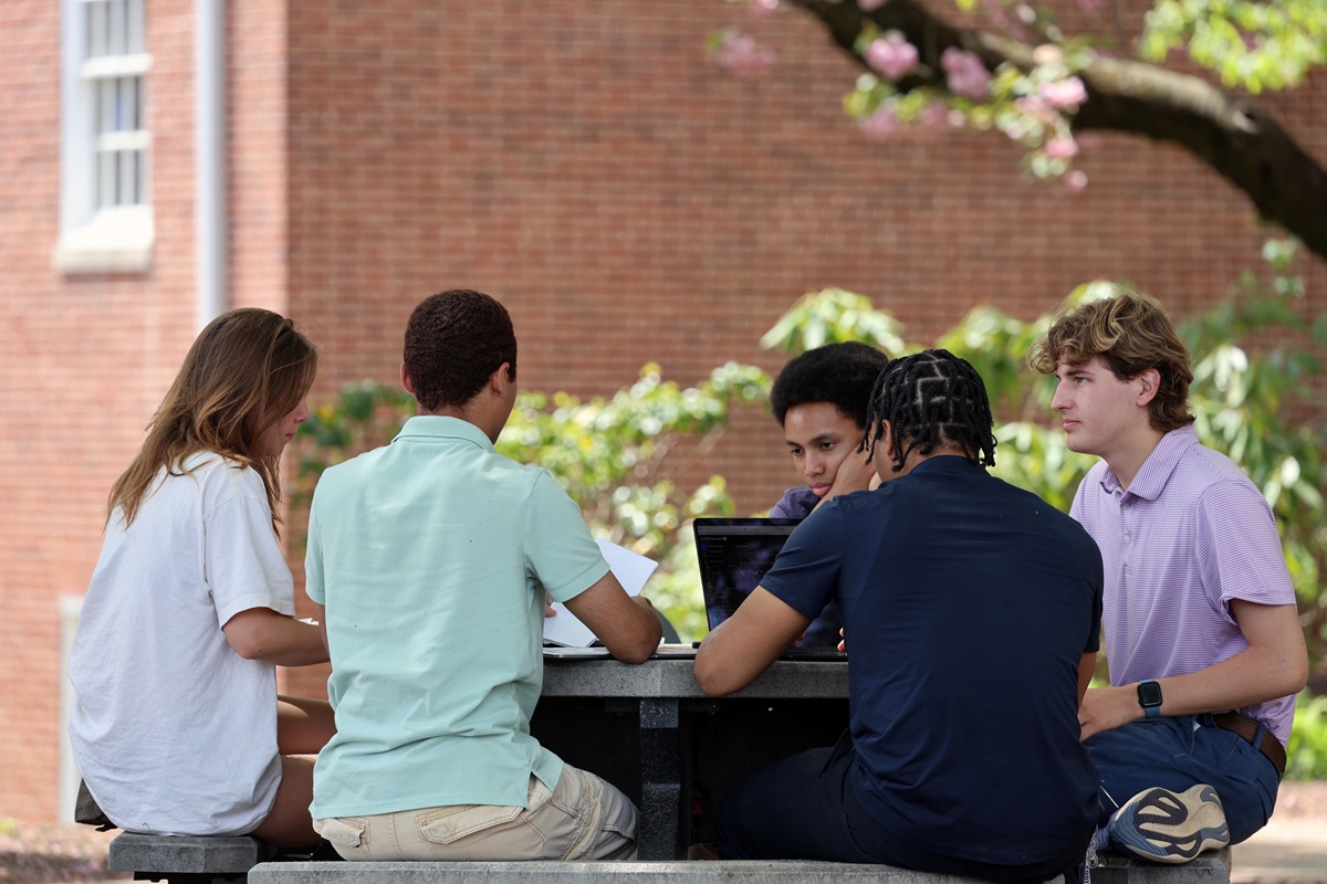 Students studying at outdoor picnic table