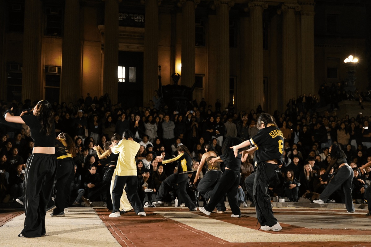Wushu athlete jumping with staff